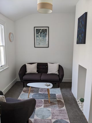 a living room with two sofas and a coffee table - therapy room Genotin terrace